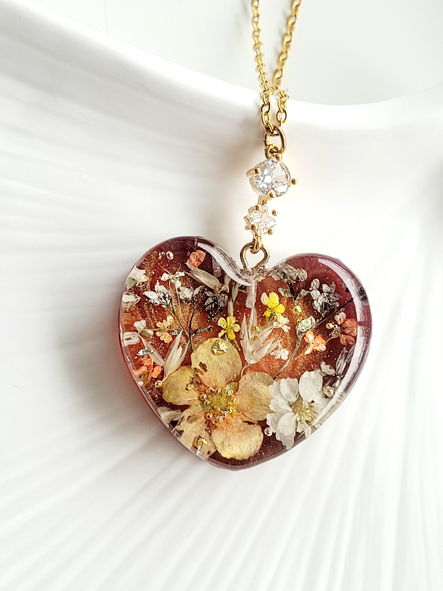 Amber like floral botanical handcrafted heart necklace with genuine flowers
