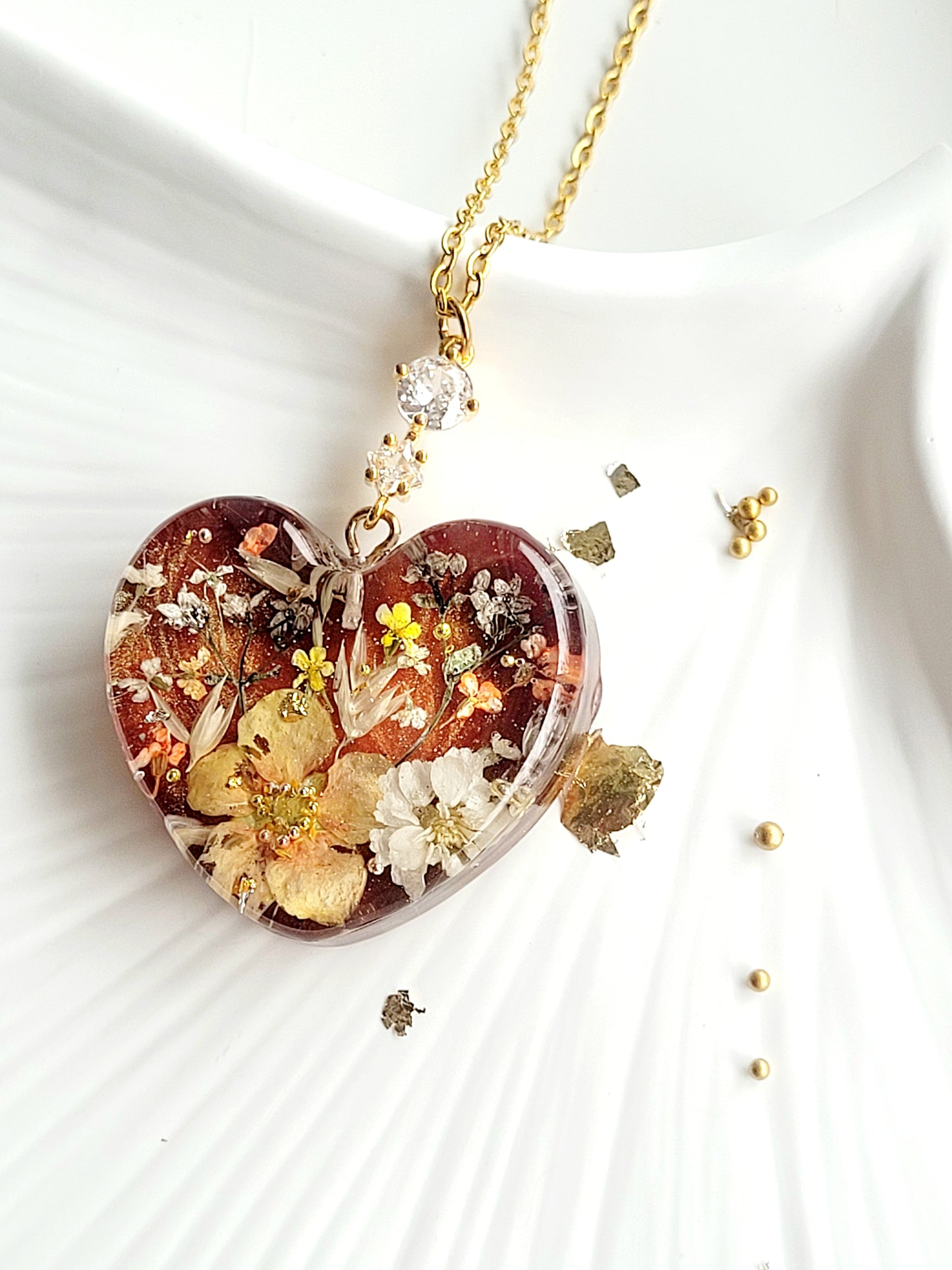 Amber like floral botanical handcrafted heart necklace with genuine flowers