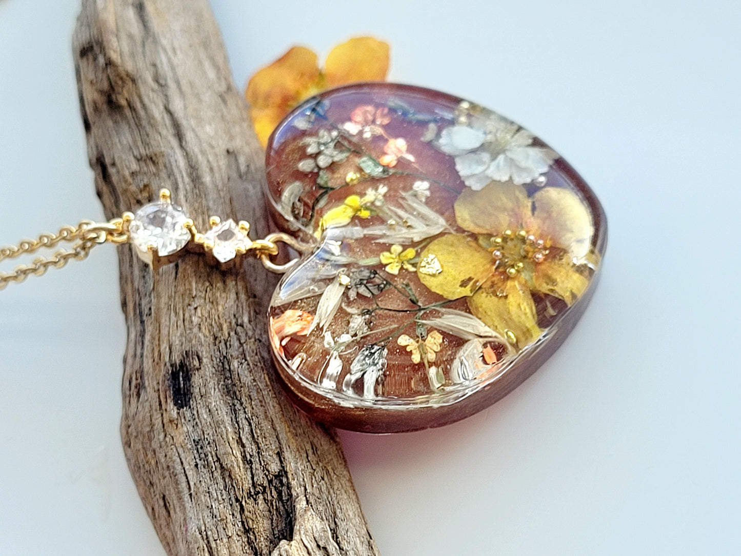 Amber like floral botanical handcrafted heart necklace with genuine flowers