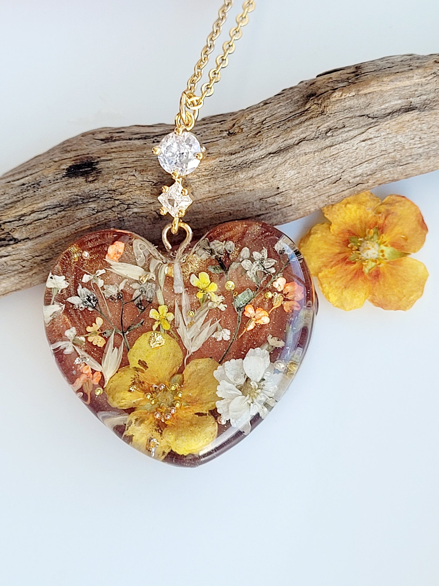 Amber like floral botanical handcrafted heart necklace with genuine flowers