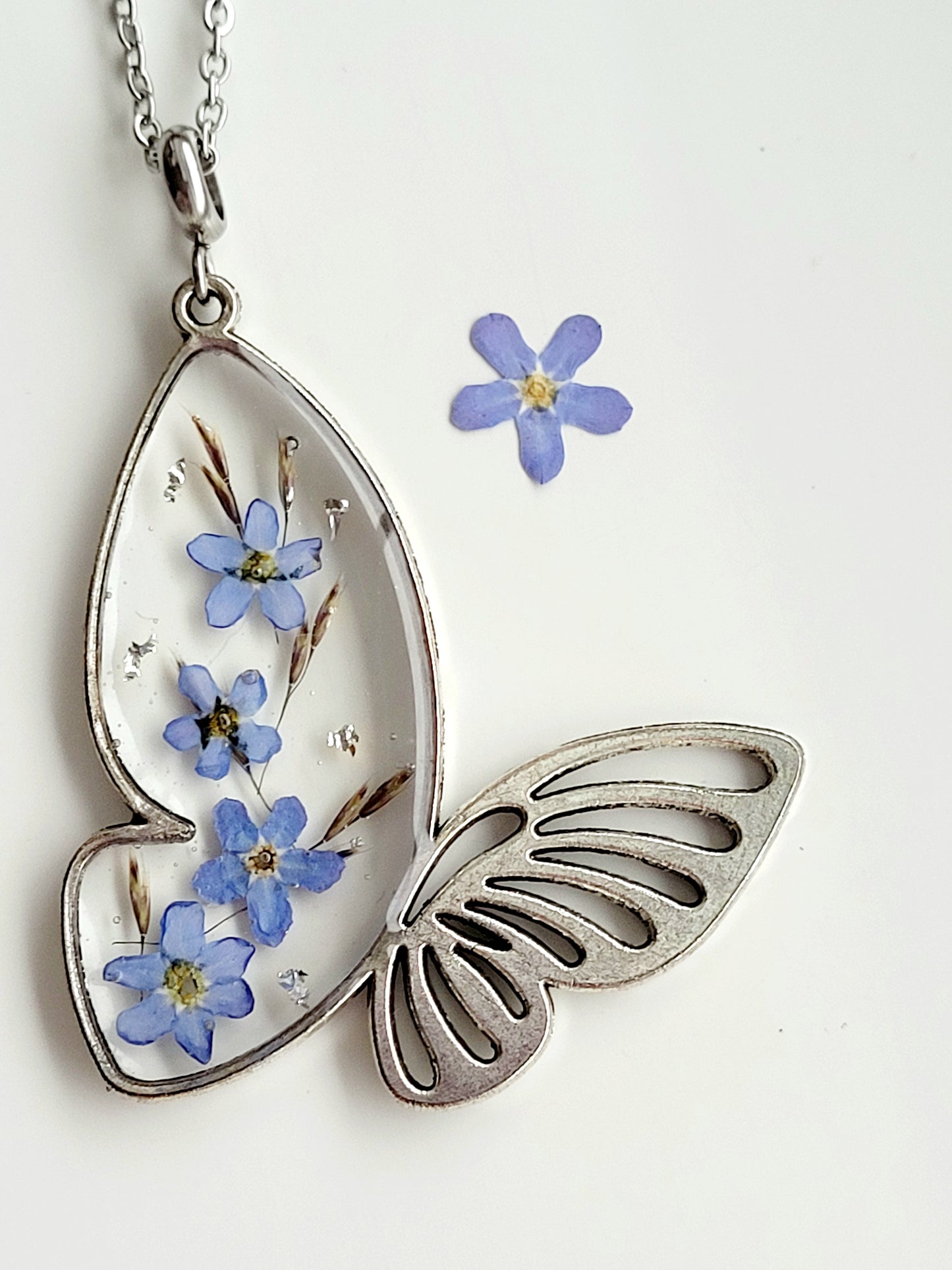 Butterfly necklace with foget me not flowers