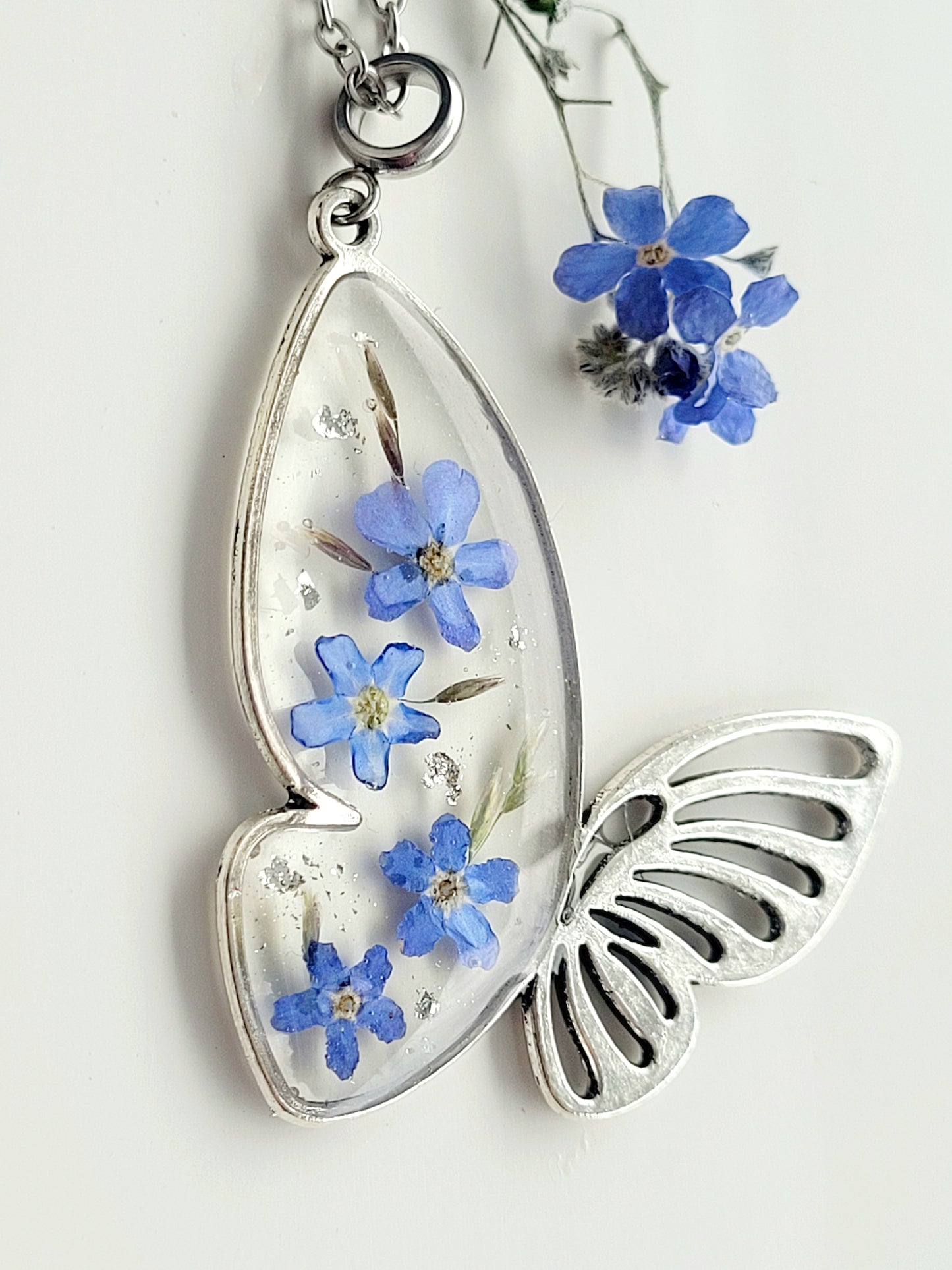 Butterfly necklace with foget me not flowers