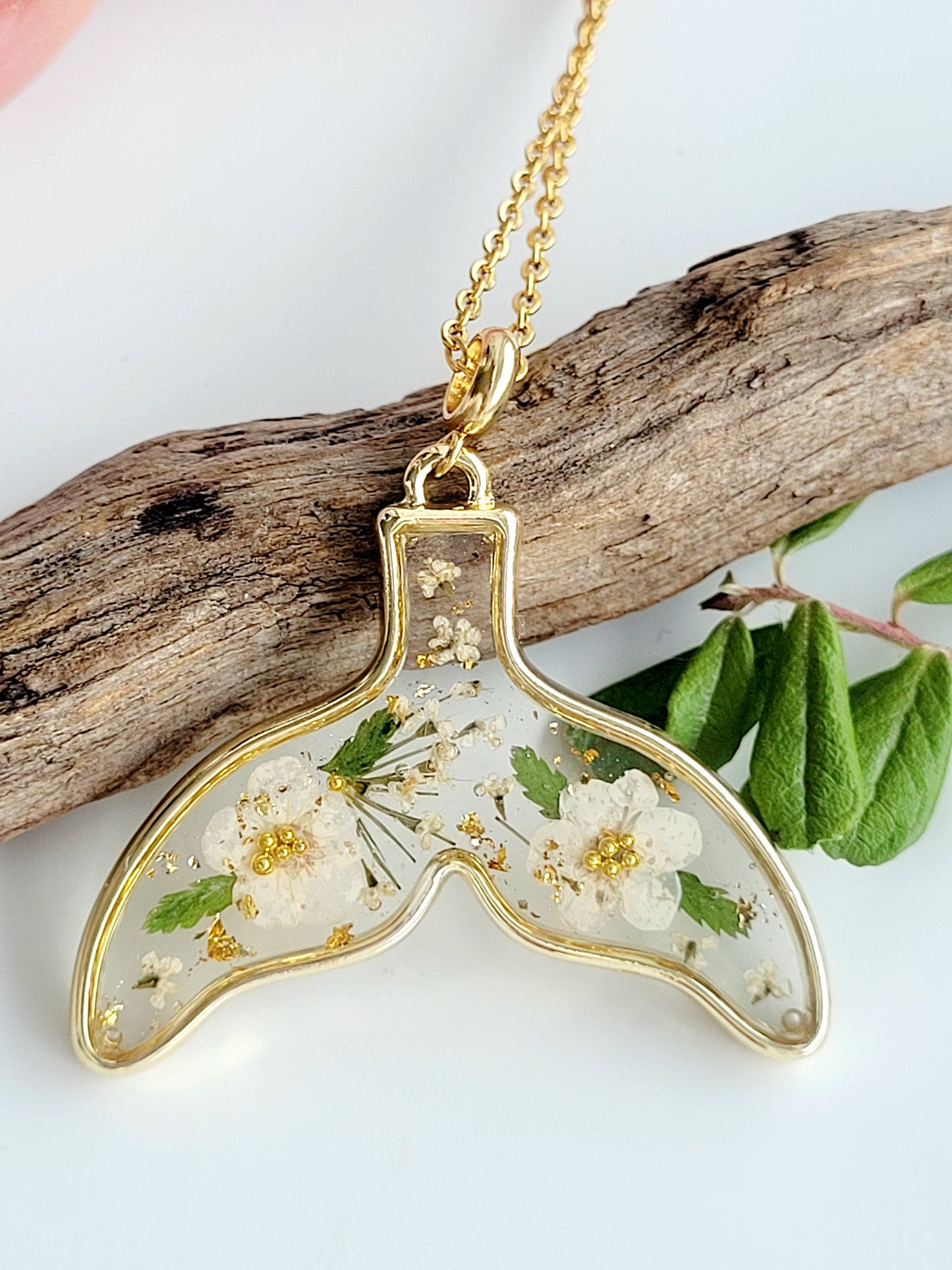 Floral whale tail necklace with genuine flowers
