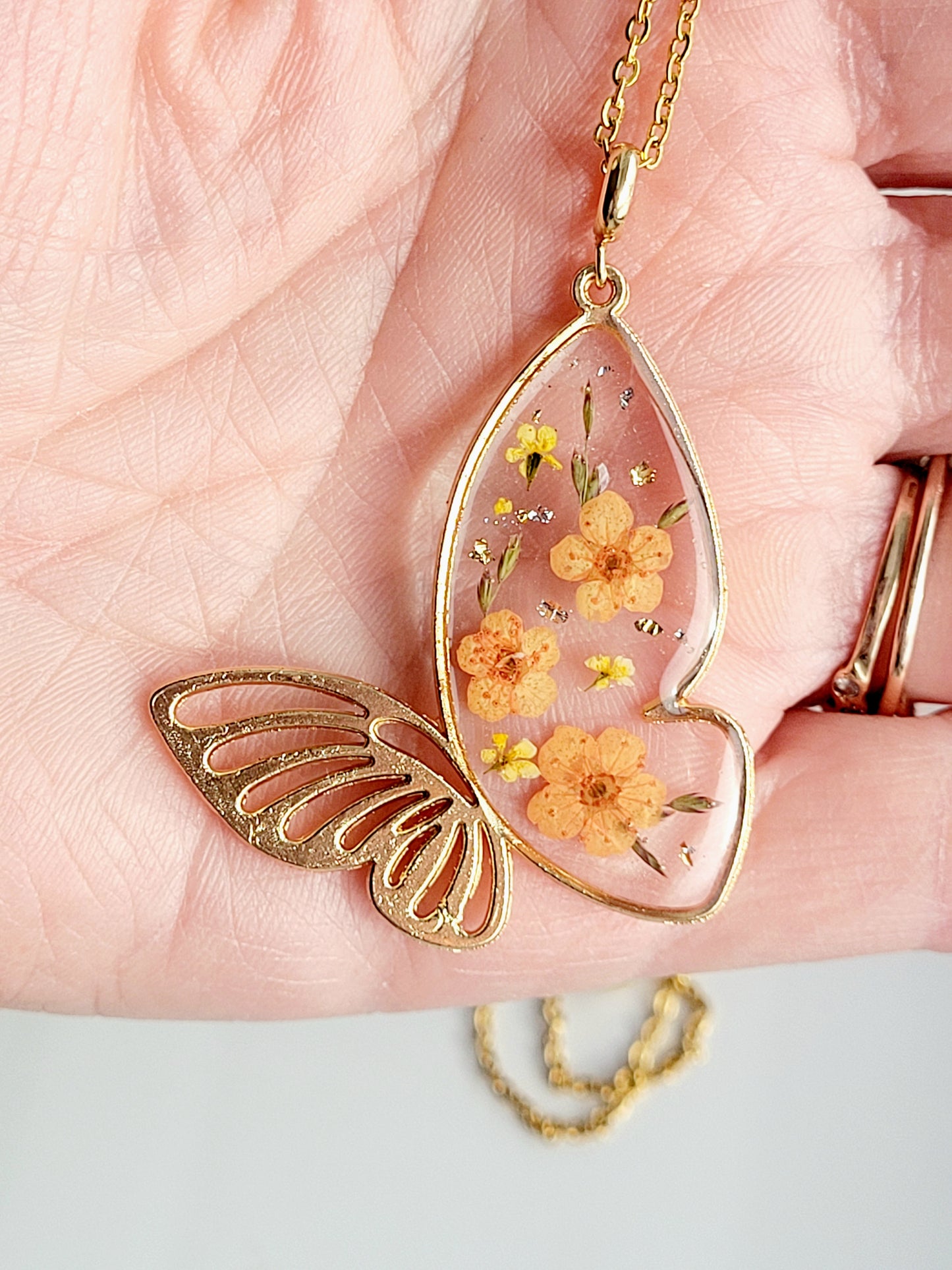 Botanical, handcrafted orange butterfly necklac with genuine flowers. Unique gift